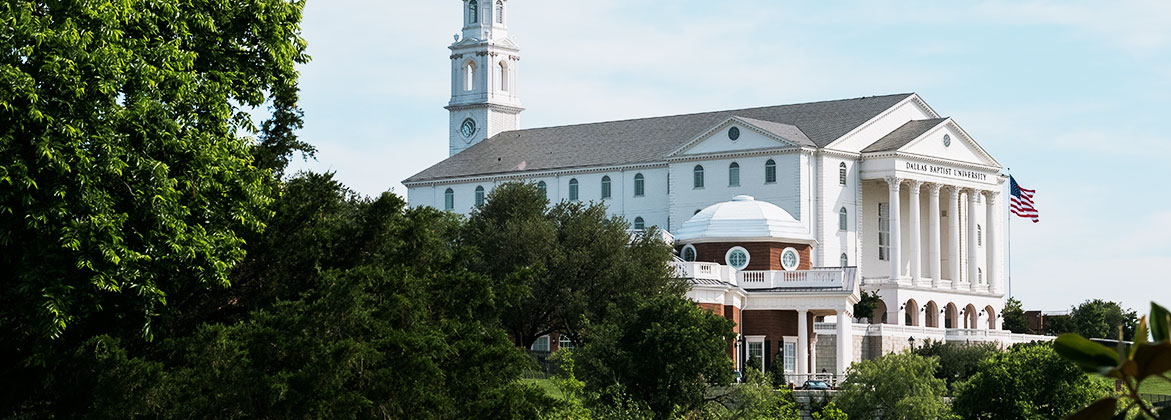 texas graduate school - nation hall and chapel with american flag and trees