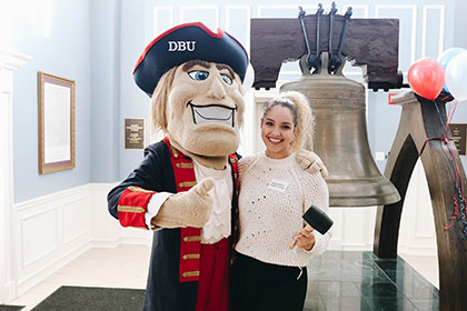 Undergraduate student with Mr. Patriot