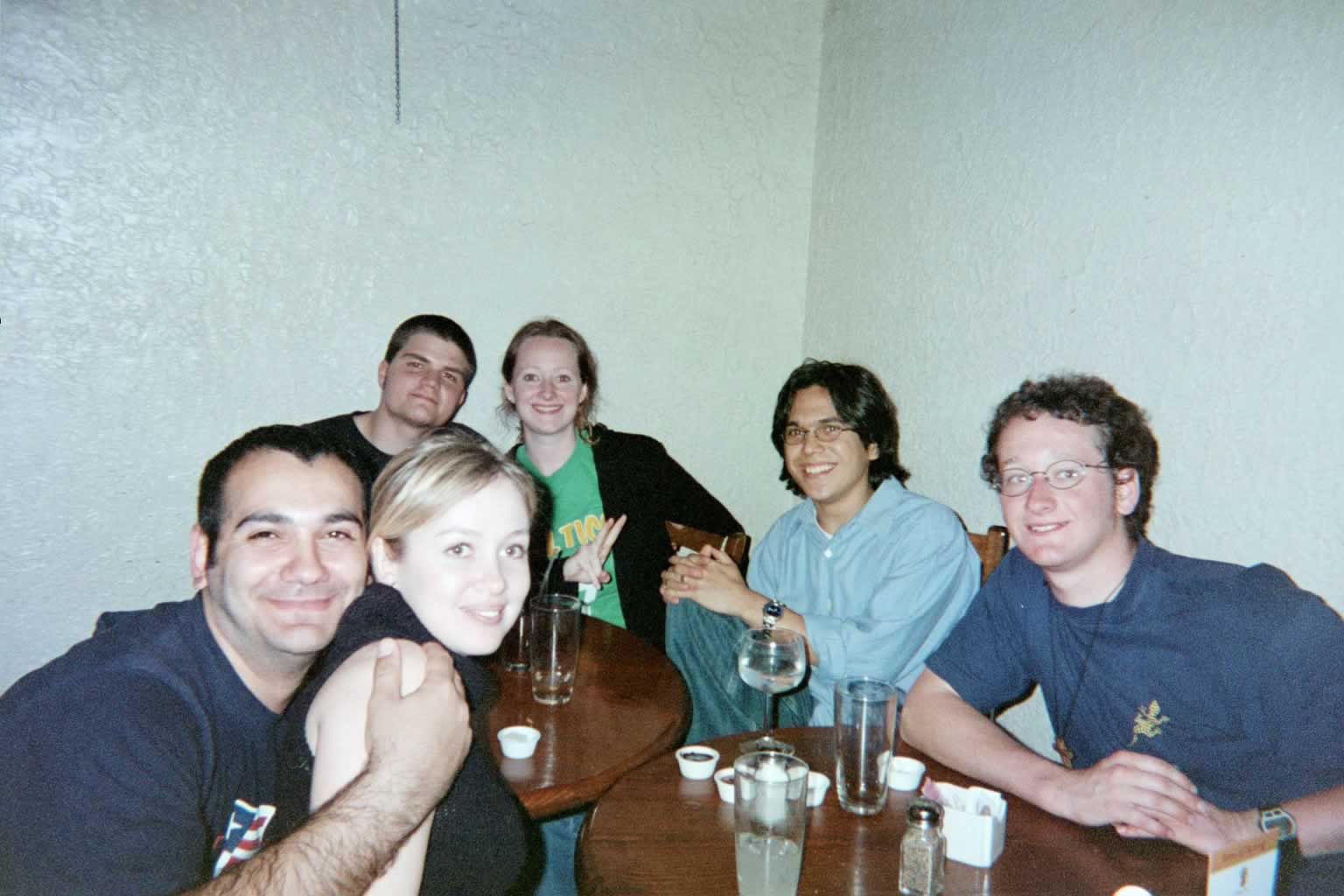 picture of a group of students sitting around a table smiling