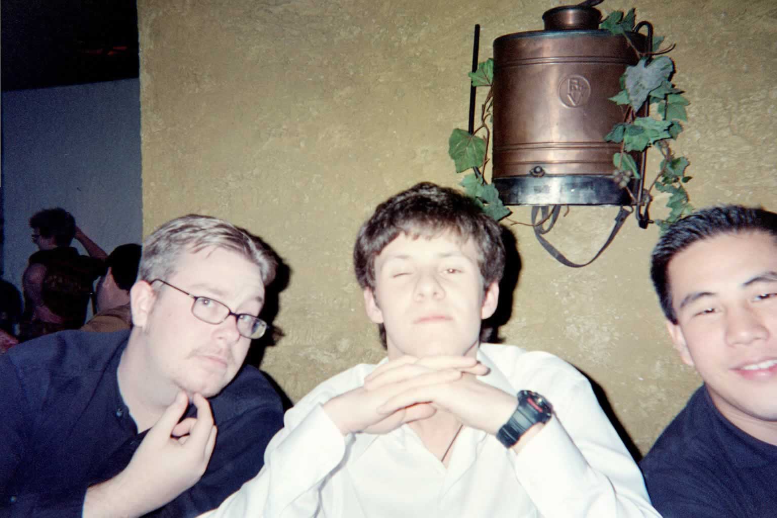 picture of 3 men posing together at a table