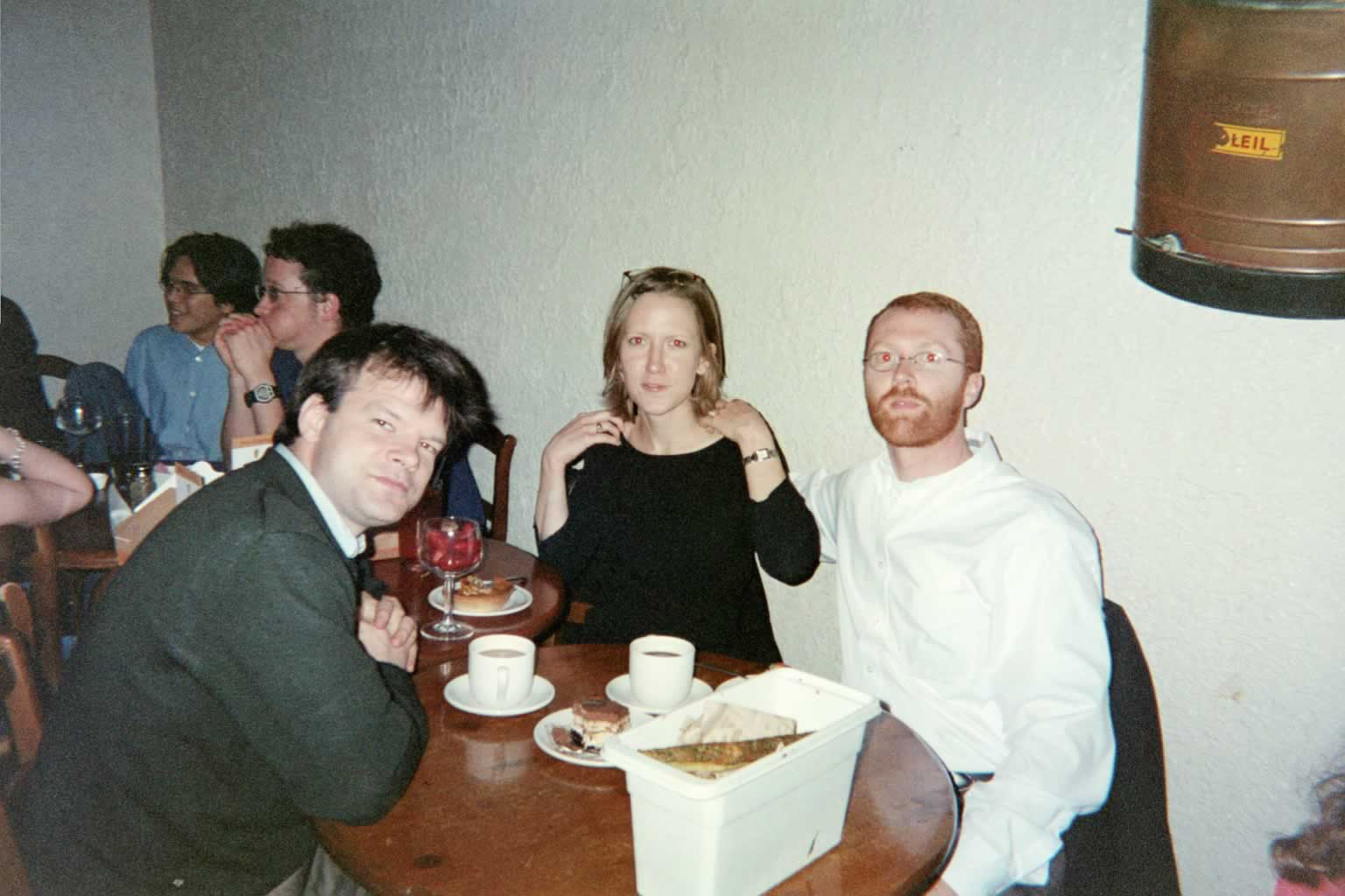 picture of two men and a woman sitting around a table