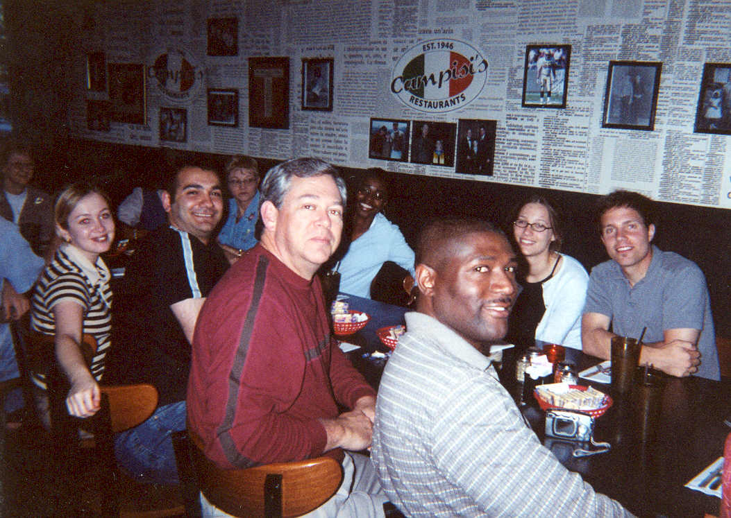 picture of a group of people sitting around a restaurant table