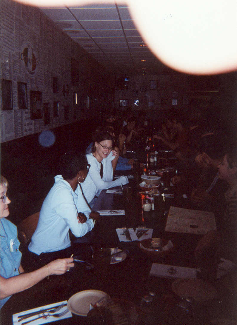 picture of a group of people sitting around a restaurant table