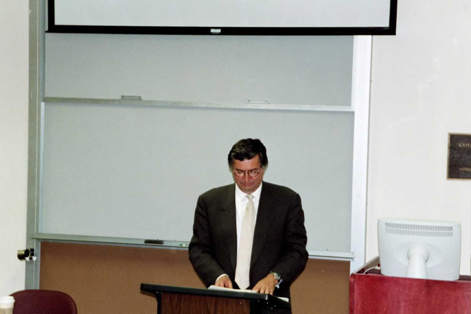 picture of Paul Marshall standing behind a podium looking down