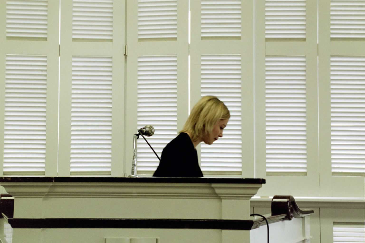 picture of a woman walking away from a podium