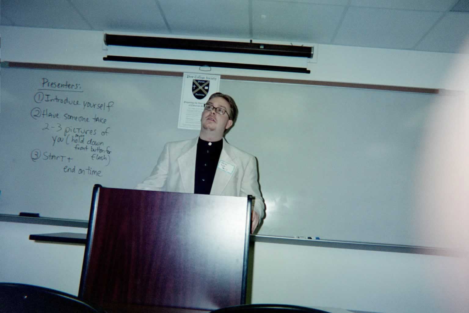 picture of a man standing behind a podium