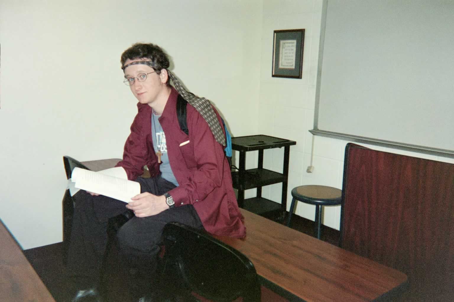 picture of a man with glasses sitting on top of a table