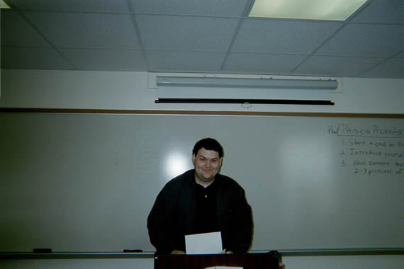 picture of a man standing behind a podium smiling