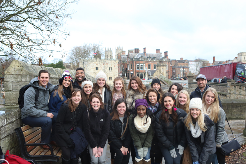 The DBU Patriettes dance team along with DBU staff sponsors in England.