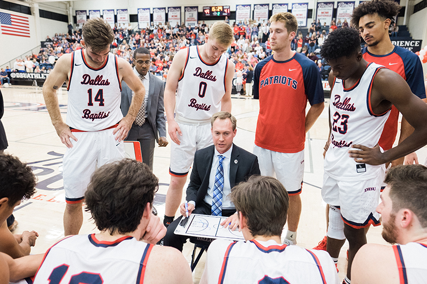 Coach Flickner walks his team through a play during a time-out