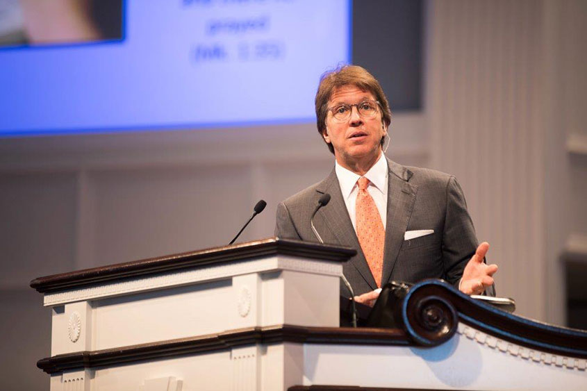 Mark Lanier speaking from behind the podium in the Chapel