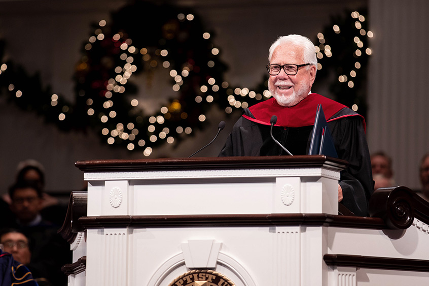 Norman E. Miller speaking at podium during December Commencement Service