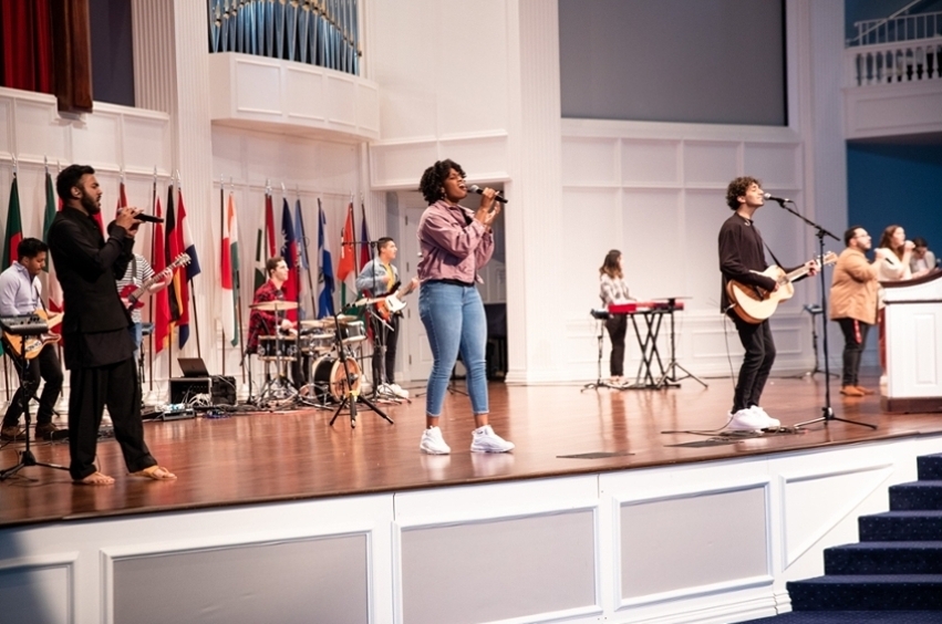 Students singing on Chapel stage