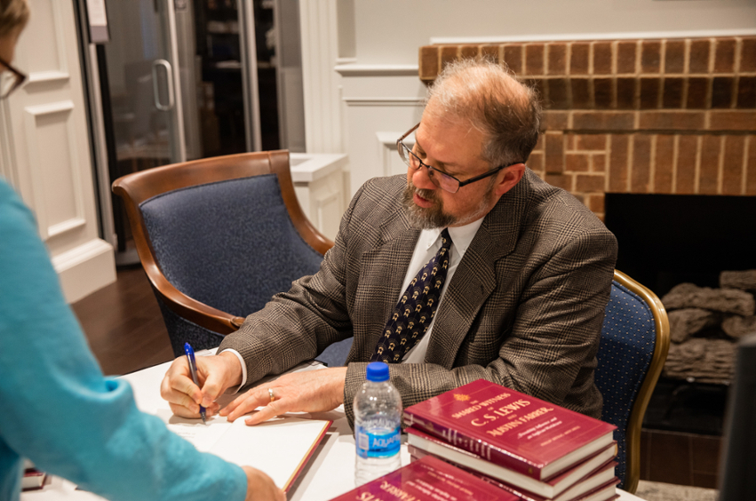 Dr. Mitchell signing his book