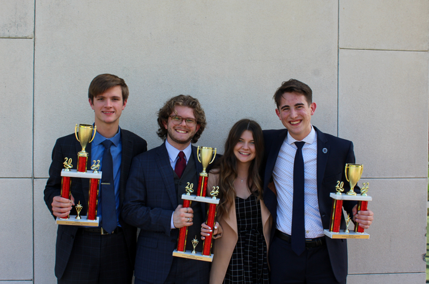 Debate Team holding trophies 