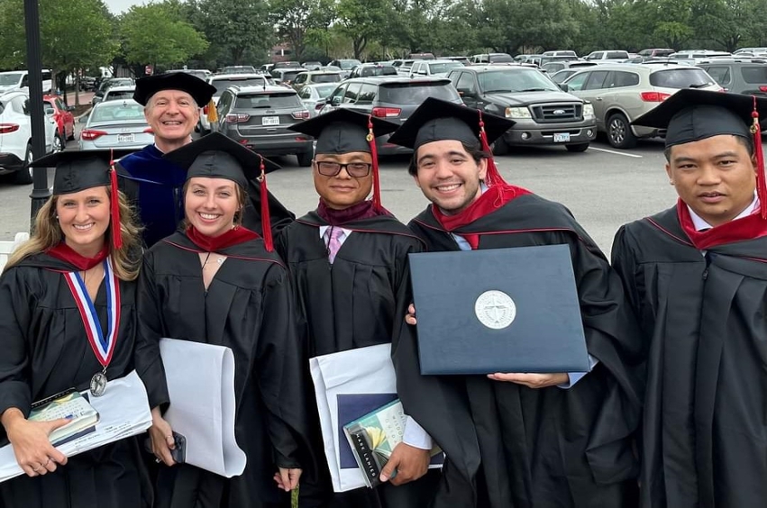 group of Dallas graduate school of ministry graduates standing outside after graduation