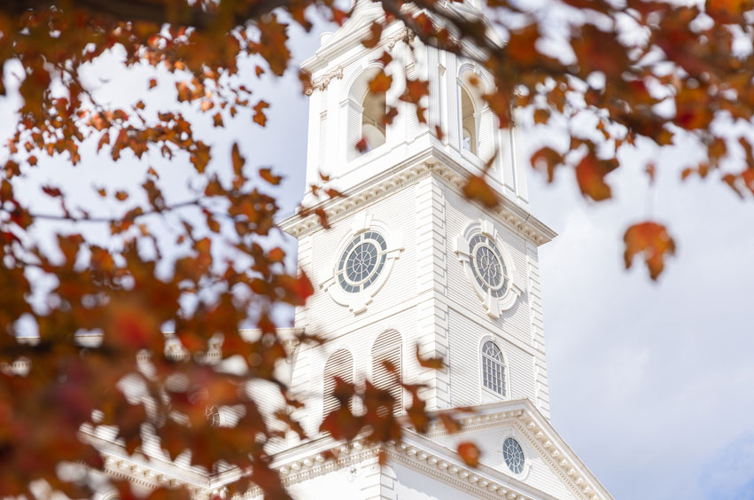 Fall leaves in front of chapel steeple