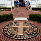 dbu insignia with students walking into chapel