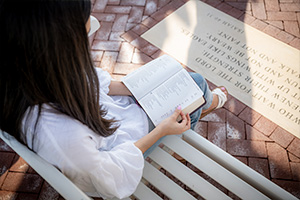 dbu student reading the bible outside