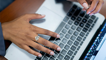 hands typing on a computer keyboard