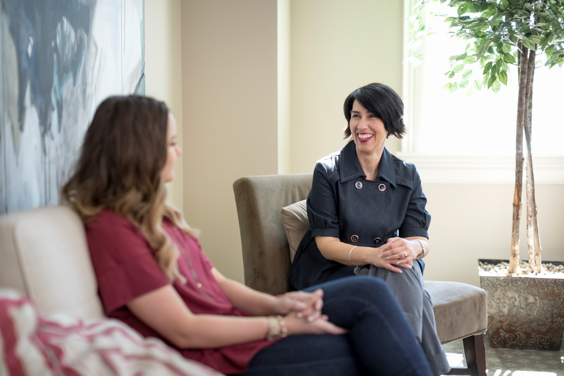 Two women talking to each other about developing a career plan sitting inside in Dallas, Texas