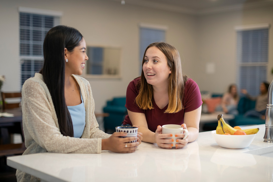 Roommates study together on their couch
