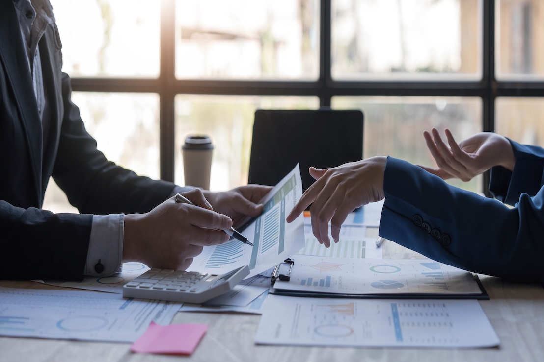 An accountant reviews paperwork with their business partner