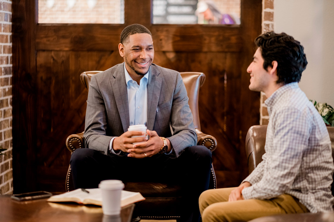 Two men wearing business attire sitting inside at a counseling session in Dallas, Texas