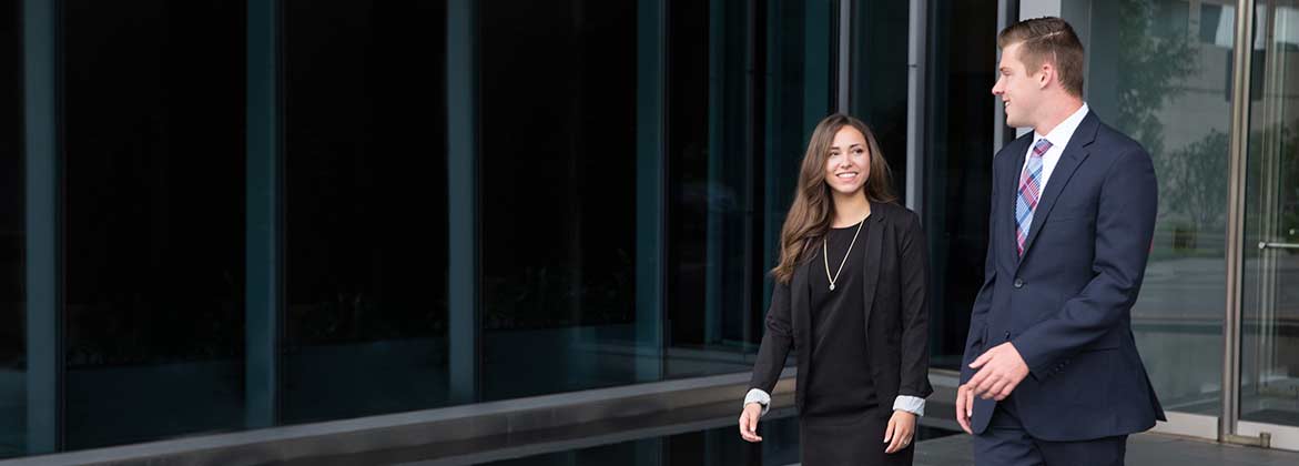 business professionals walking outside a office building in downtown Dallas