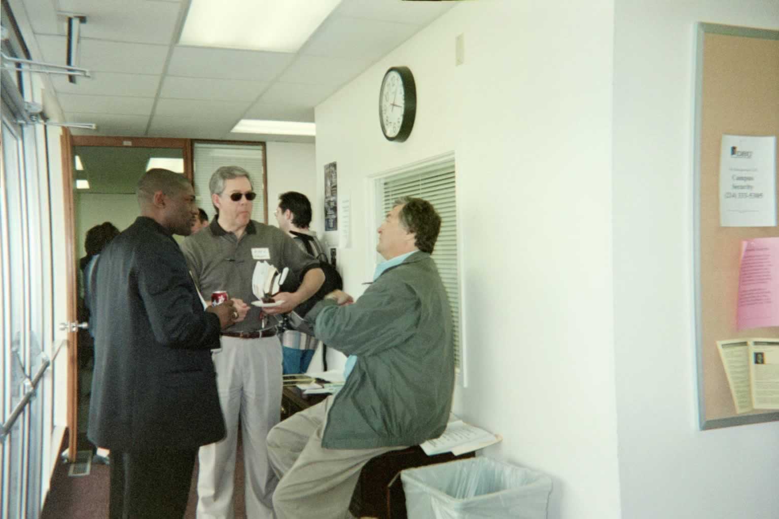 picture of Paul Marshall conversing with two other men