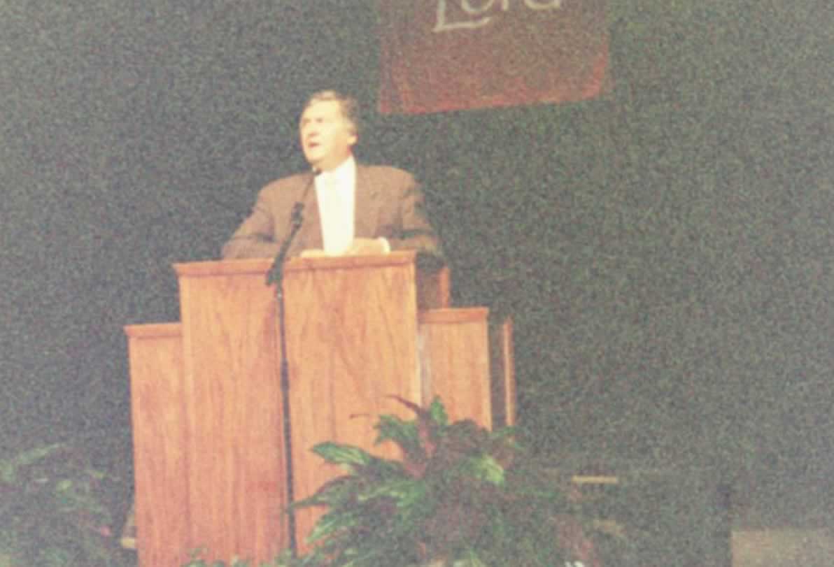 picture of Paul Marsahll standing behind a podium and speaking