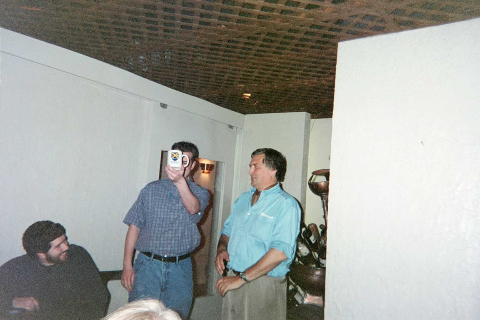 picture of Paul Marshall standing next to a man holding a mug in front of his face