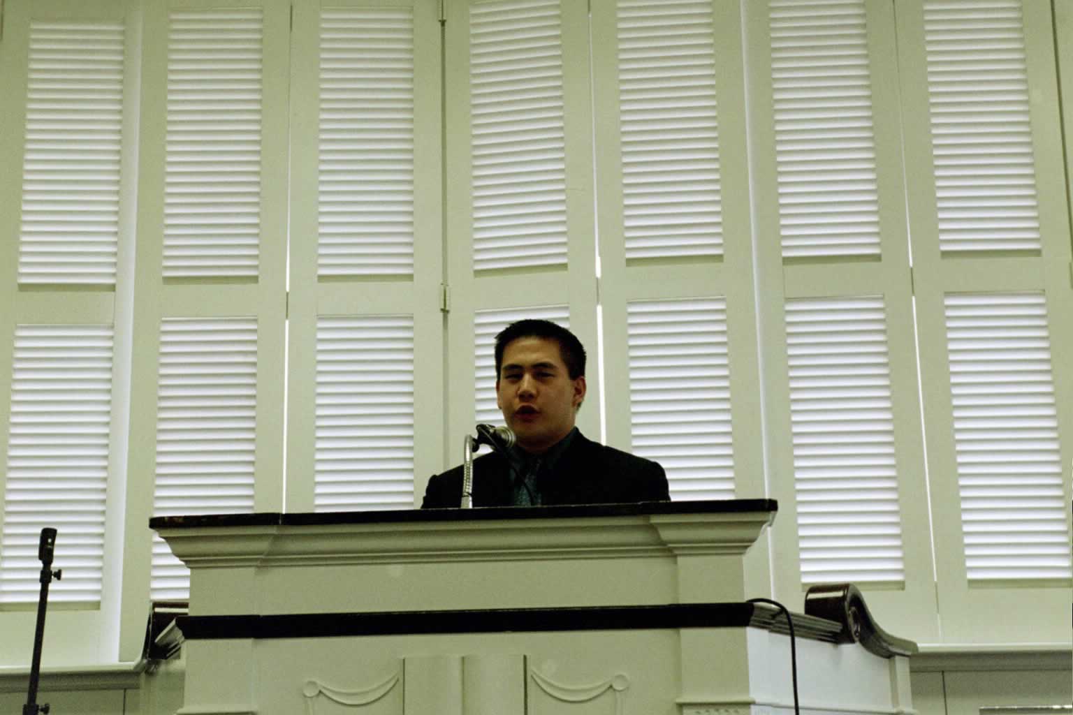 picture of man standing behind a podium speaking
