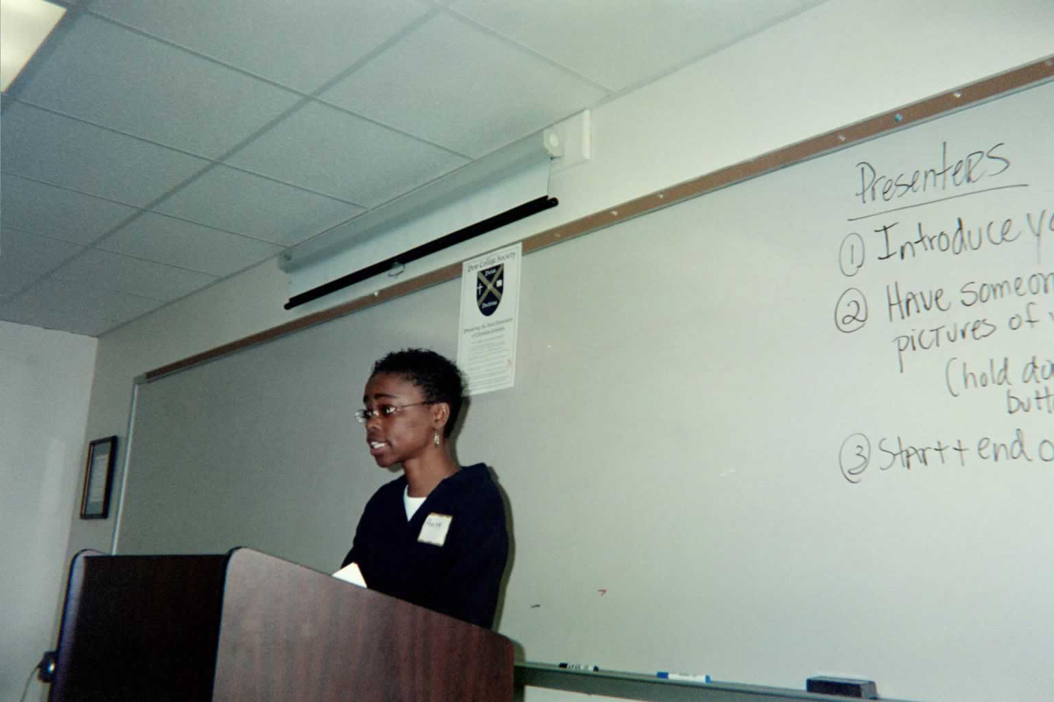 picture of a woman standing behind a podium talking