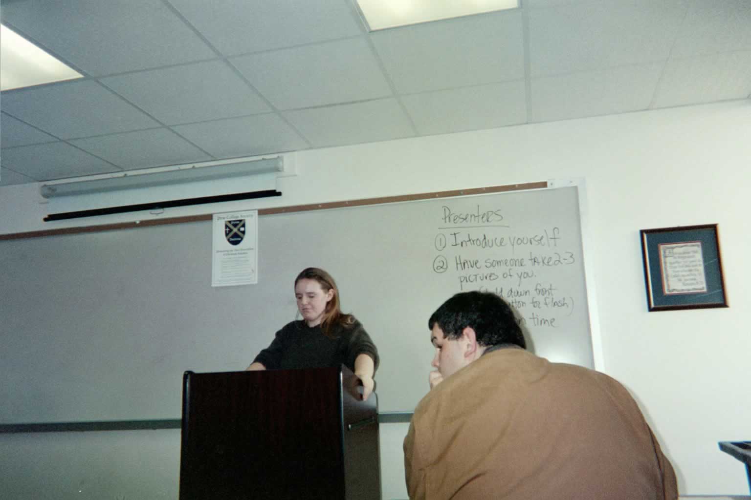 picture of a woman standing behind a podium speaking