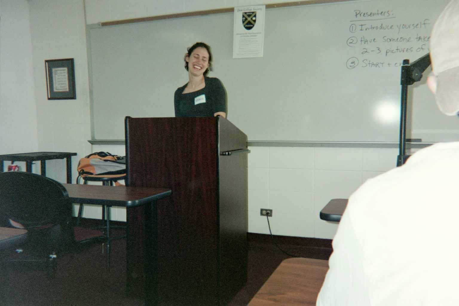 picture of a woman smiling behind a podium