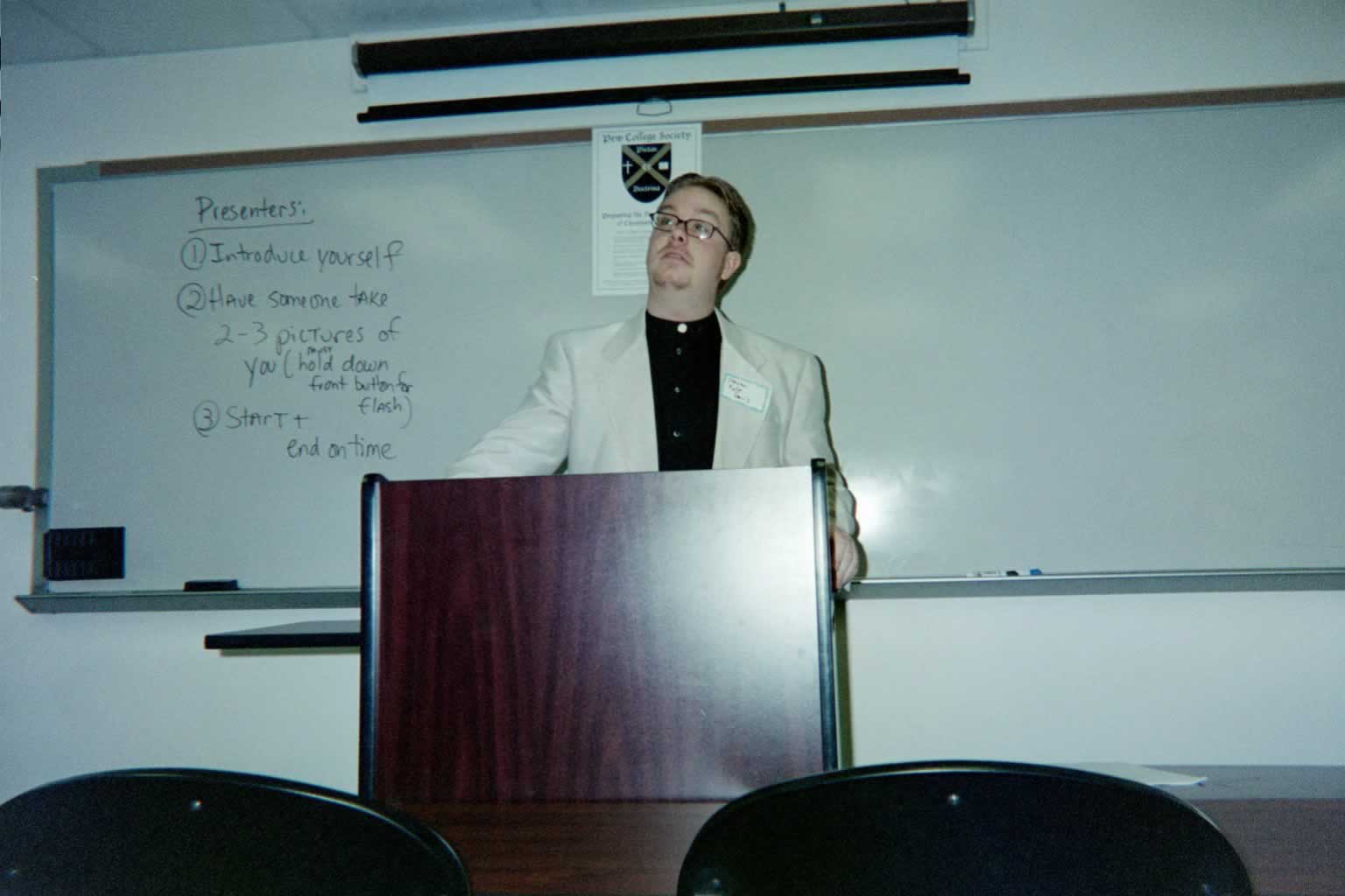picture of a man standing behind a podium