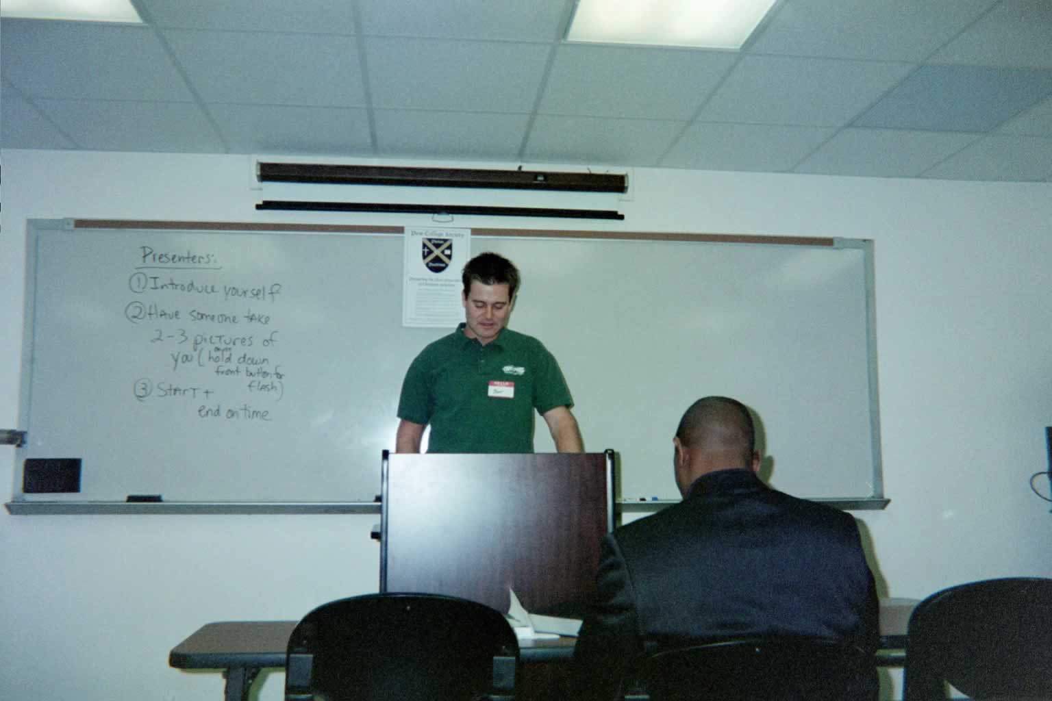 picture of a man standing behind a podium reading