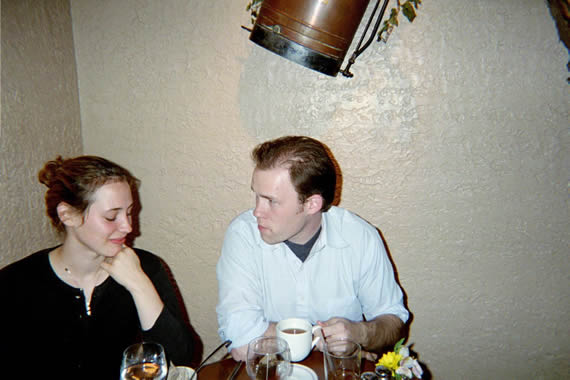 picture of a man and a woman talking while sitting down at a table