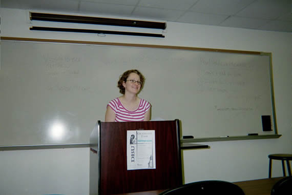 picture of a woman standing behind a podium at the front of a classroom