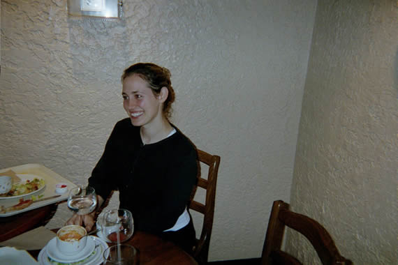 picture of a woman smiling while sitting at a resturant table