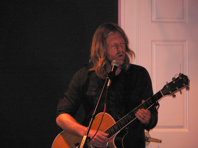 picture of Jon Foreman singing into a microphone while playing guitar