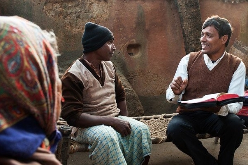 Three people reading the Bible