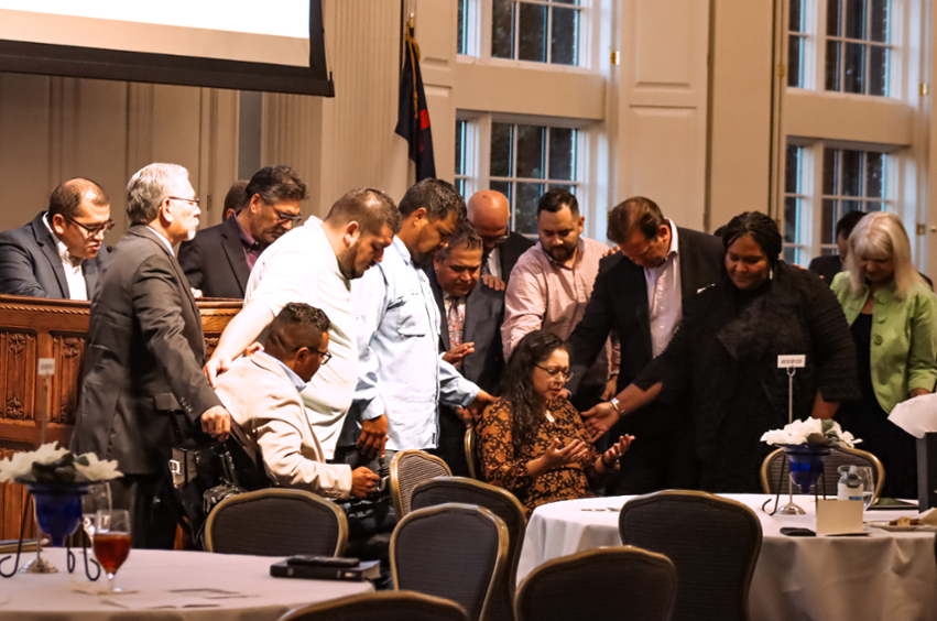 Group prays over Dr. Irene Gallegos