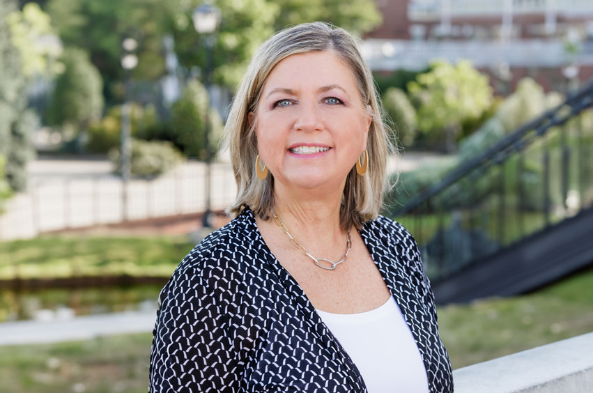 professor dana wicker standing outside on the DBU campus in Dallas