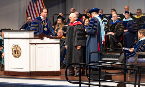 Mr. John Clem receiving his Honorary Doctor of Humanities degree at DBU