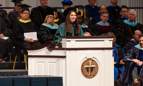 Dr. Debra Hinson delivering commencement address to graduates