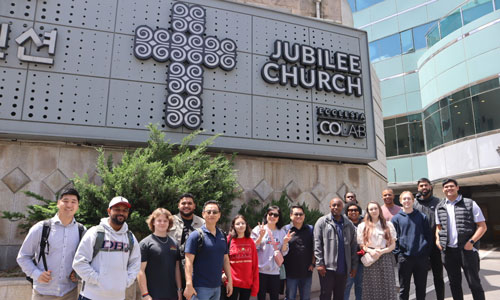 photo of DBU students and professors in front of Jubilee Church