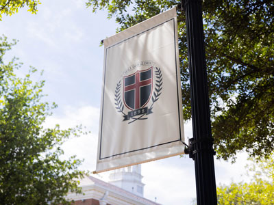 A banner with the DBU logo on the DBU campus in Dallas