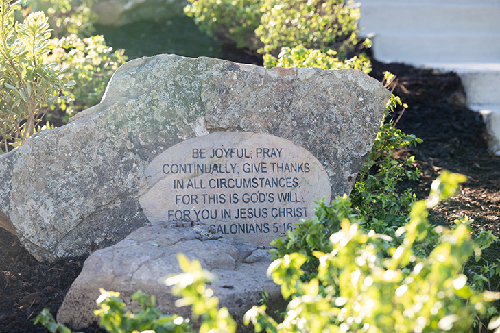 1 Thessalonians 5:16-18 written on a stone at the Pool of Bethesda on the DBU in Dallas, Texas